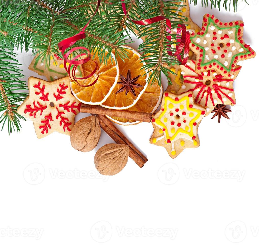 Christmas cookies, spices and spruce branches isolated on white background photo