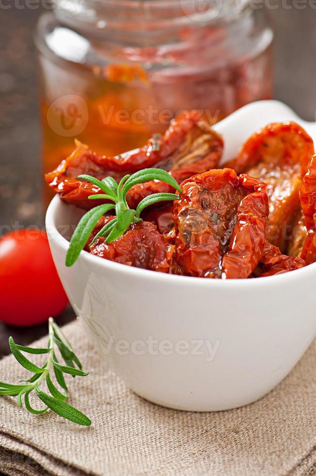 Dried tomatoes and rosemary photo