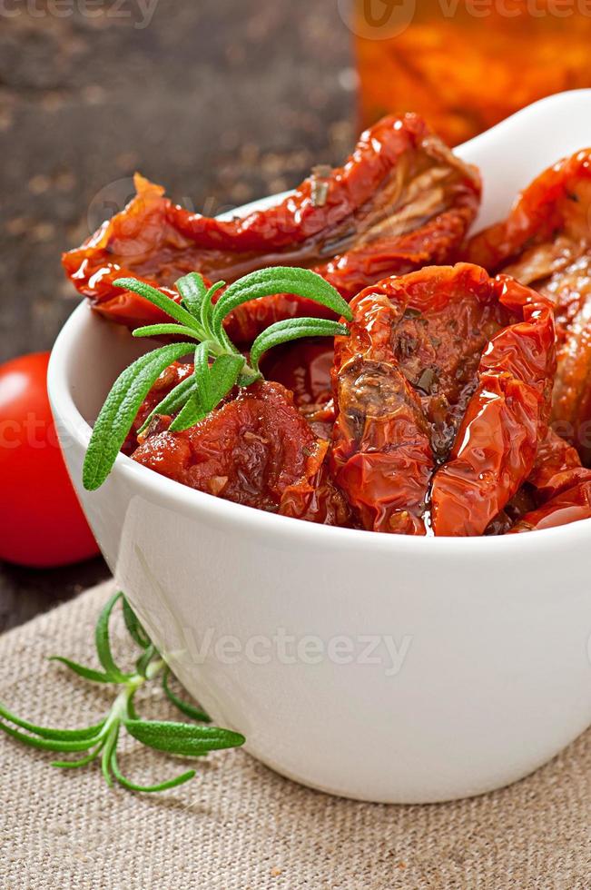 Dried tomatoes and rosemary photo