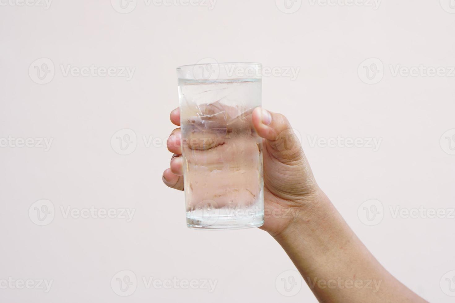 Asian woman holding a glass of cold water for drinking photo