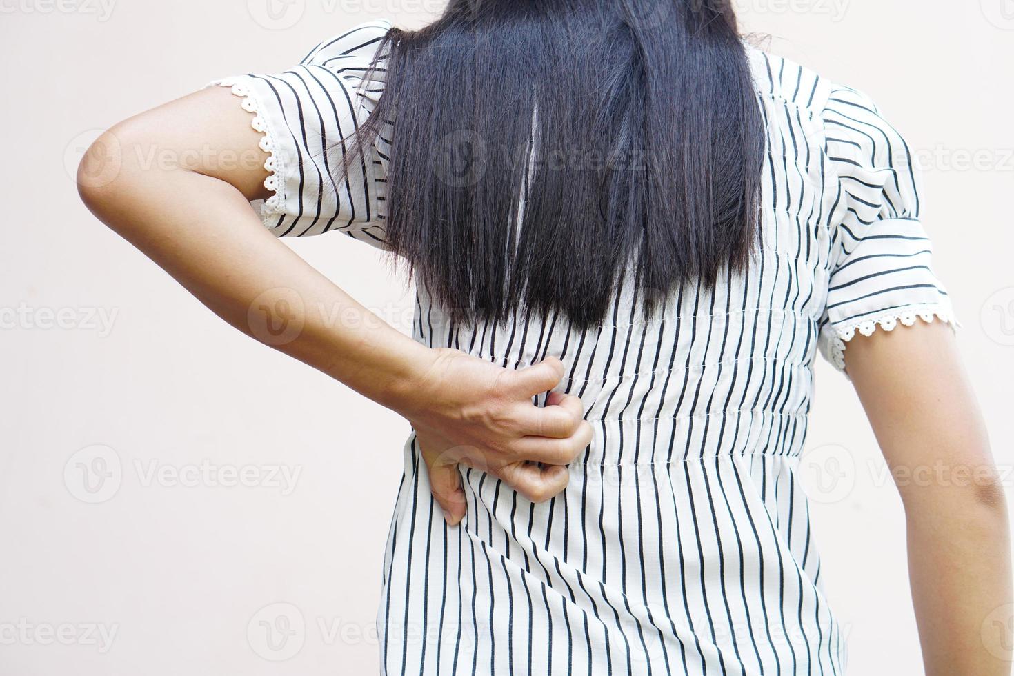 Backside of white woman back pain and ache concept,Itchy Asian woman in the back photo