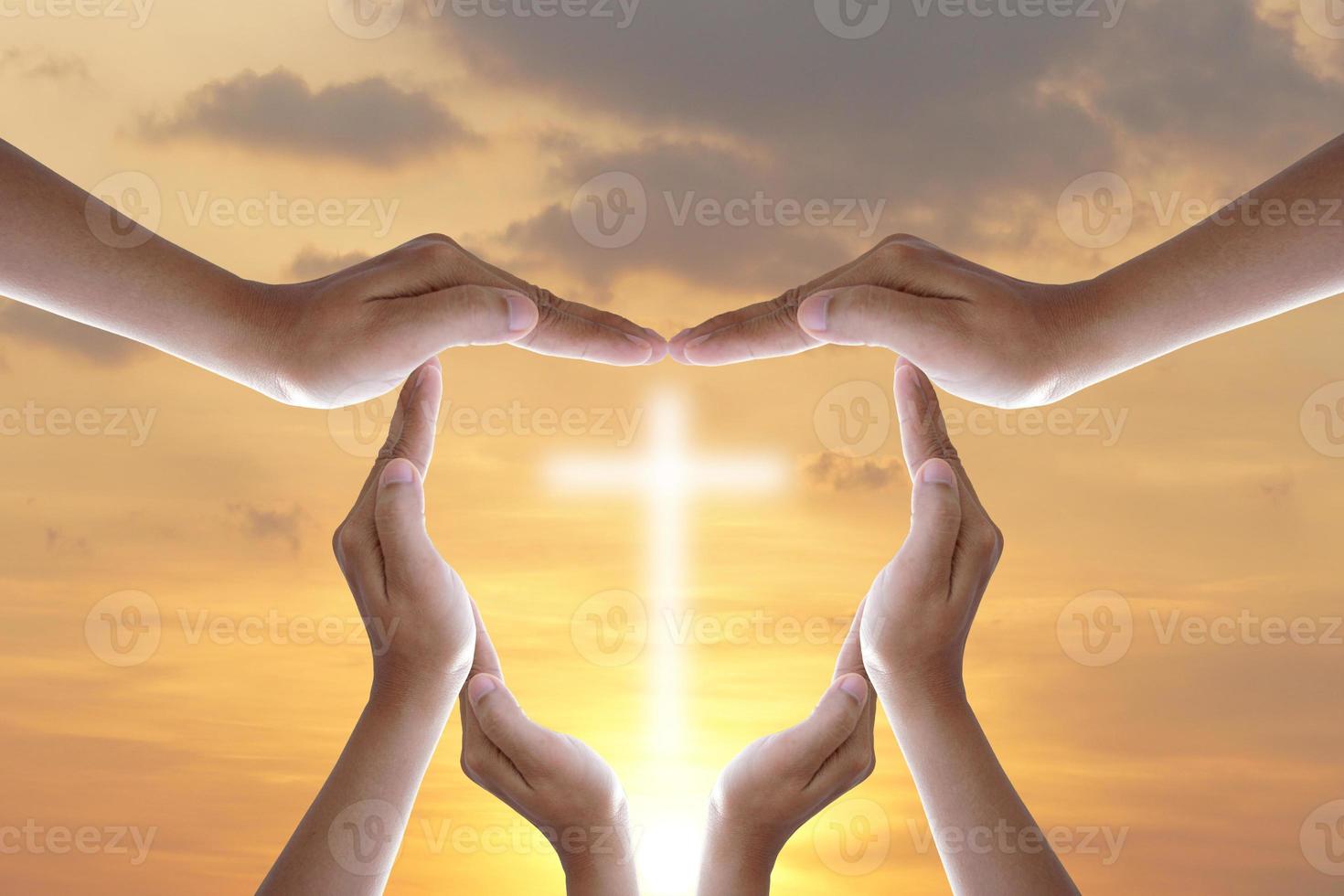 Hands bless the cross in the sky. photo