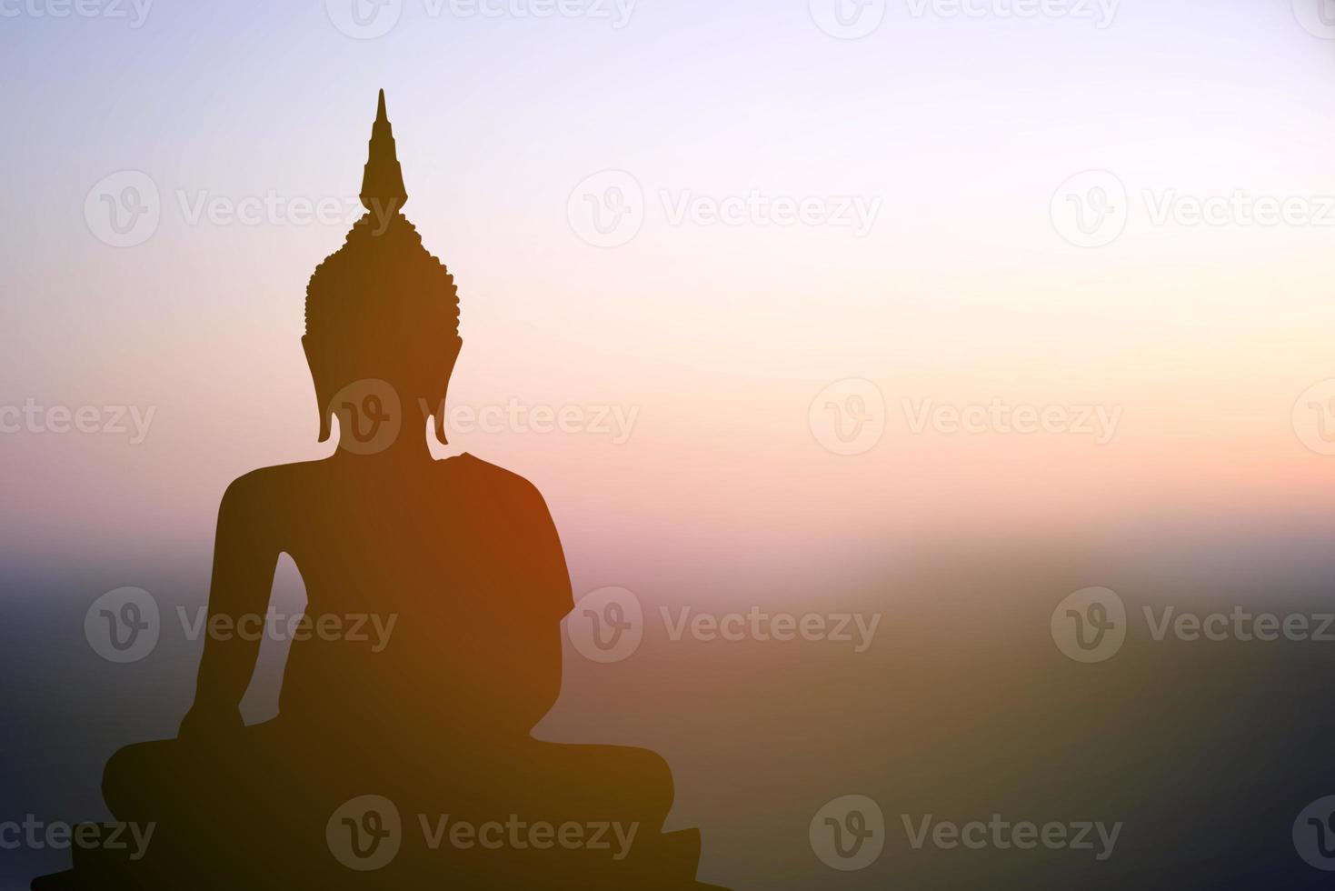 big buddha silhouette sunset background photo