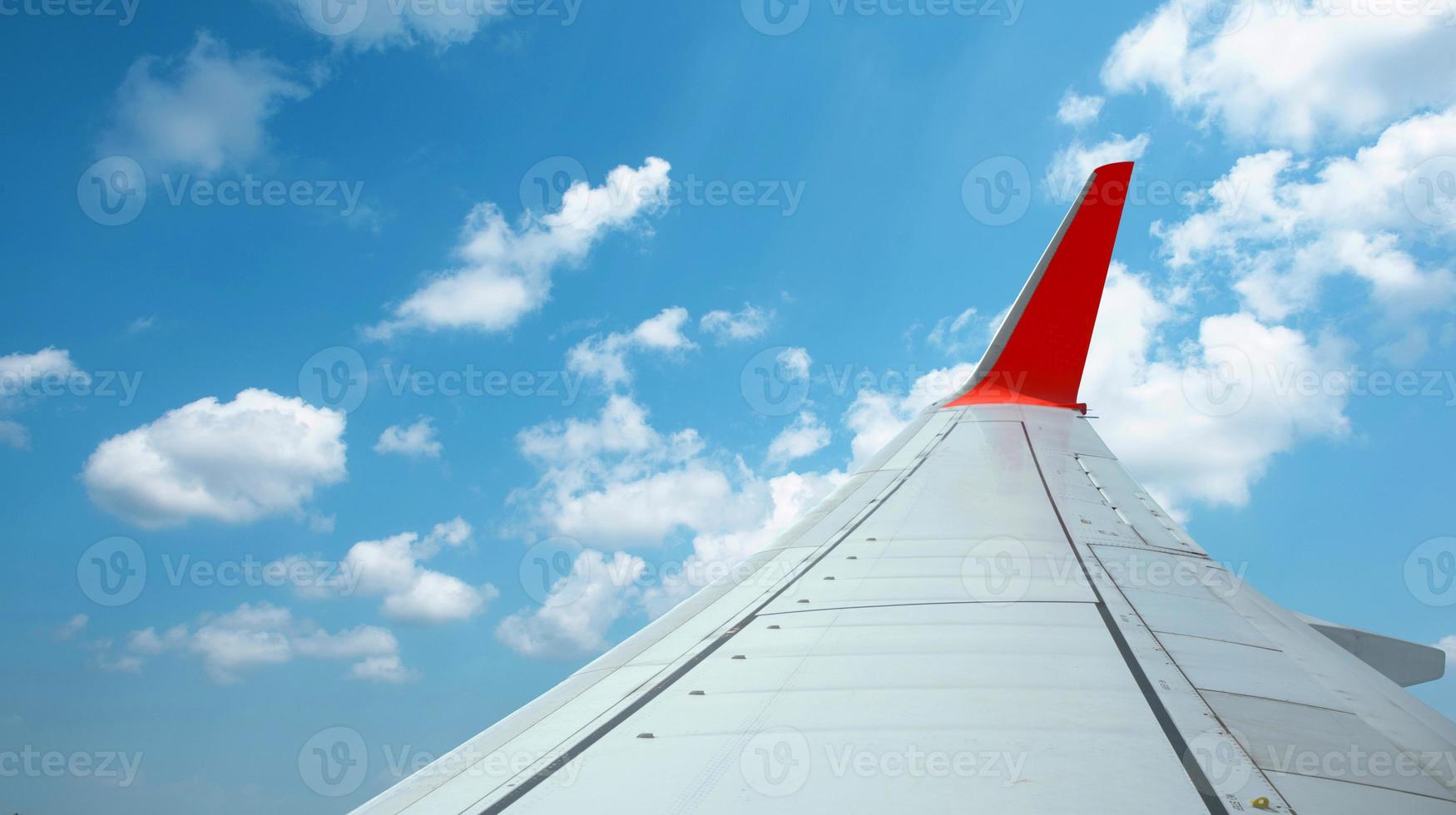 The wings of an airplane flying above the clouds. photo