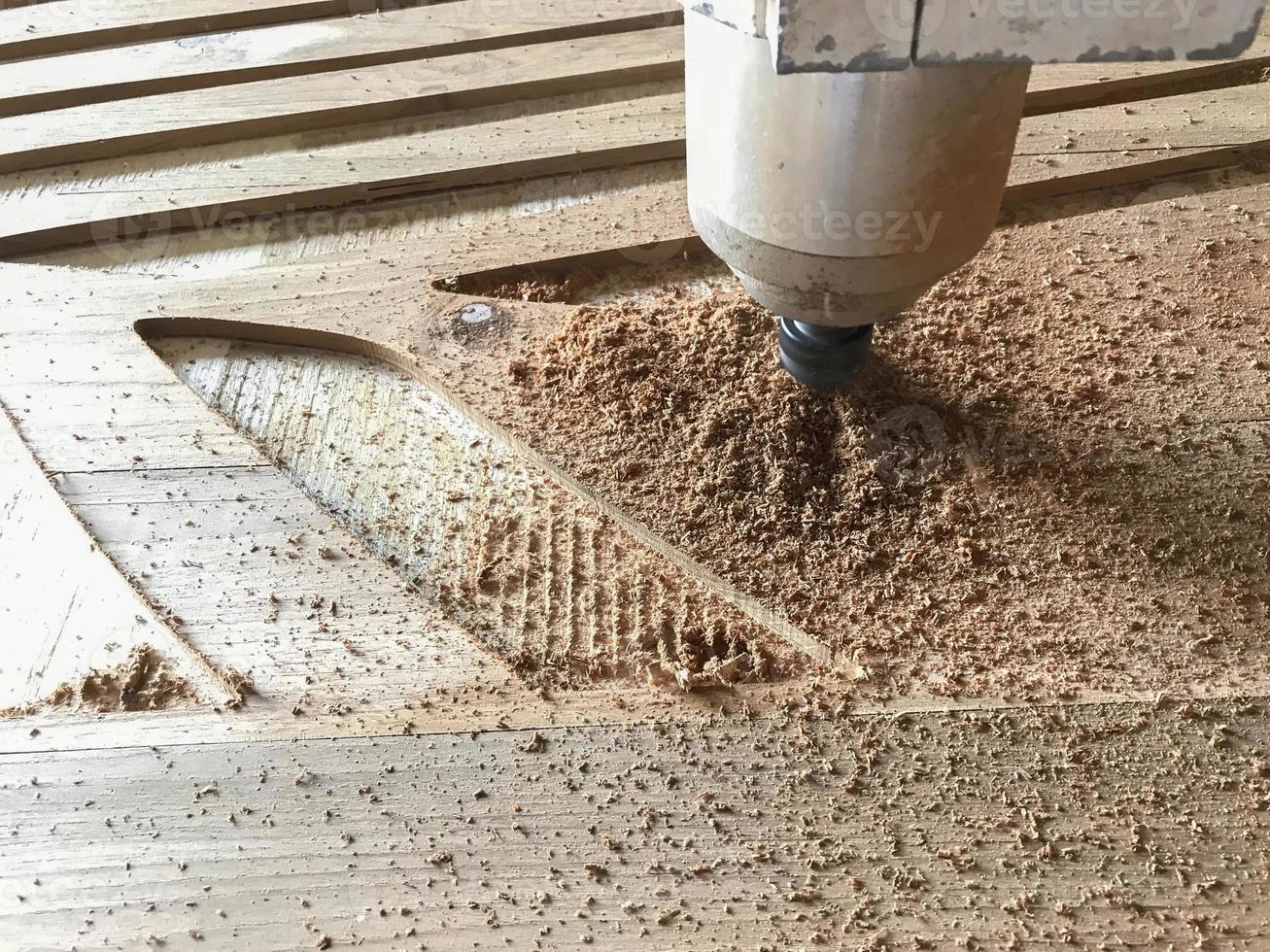 CNC laser machine working process on wooden door for making grooves by computer control. Selective focus. photo