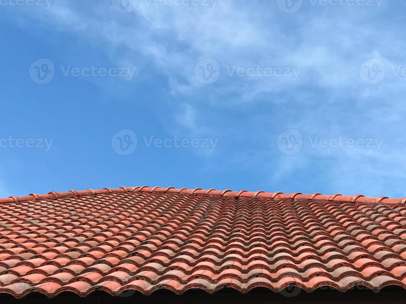 Perspective red roof tiles with copy space blue sky. photo