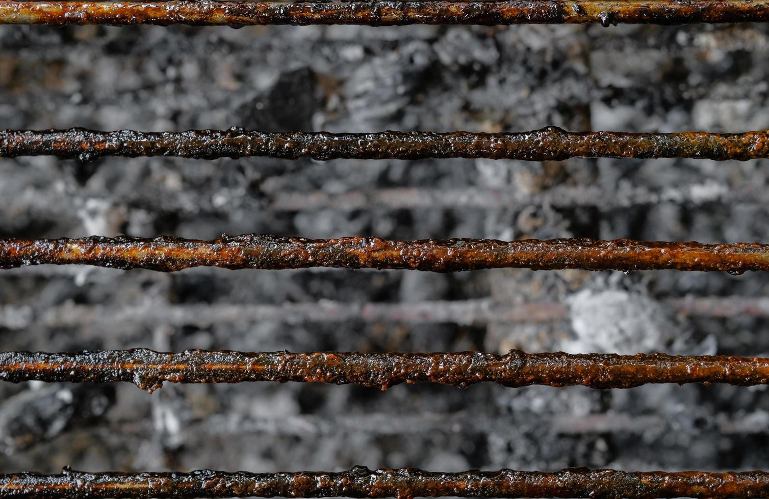 Top view close up dirty stains texture of charcoal grill after use with ashes background. photo