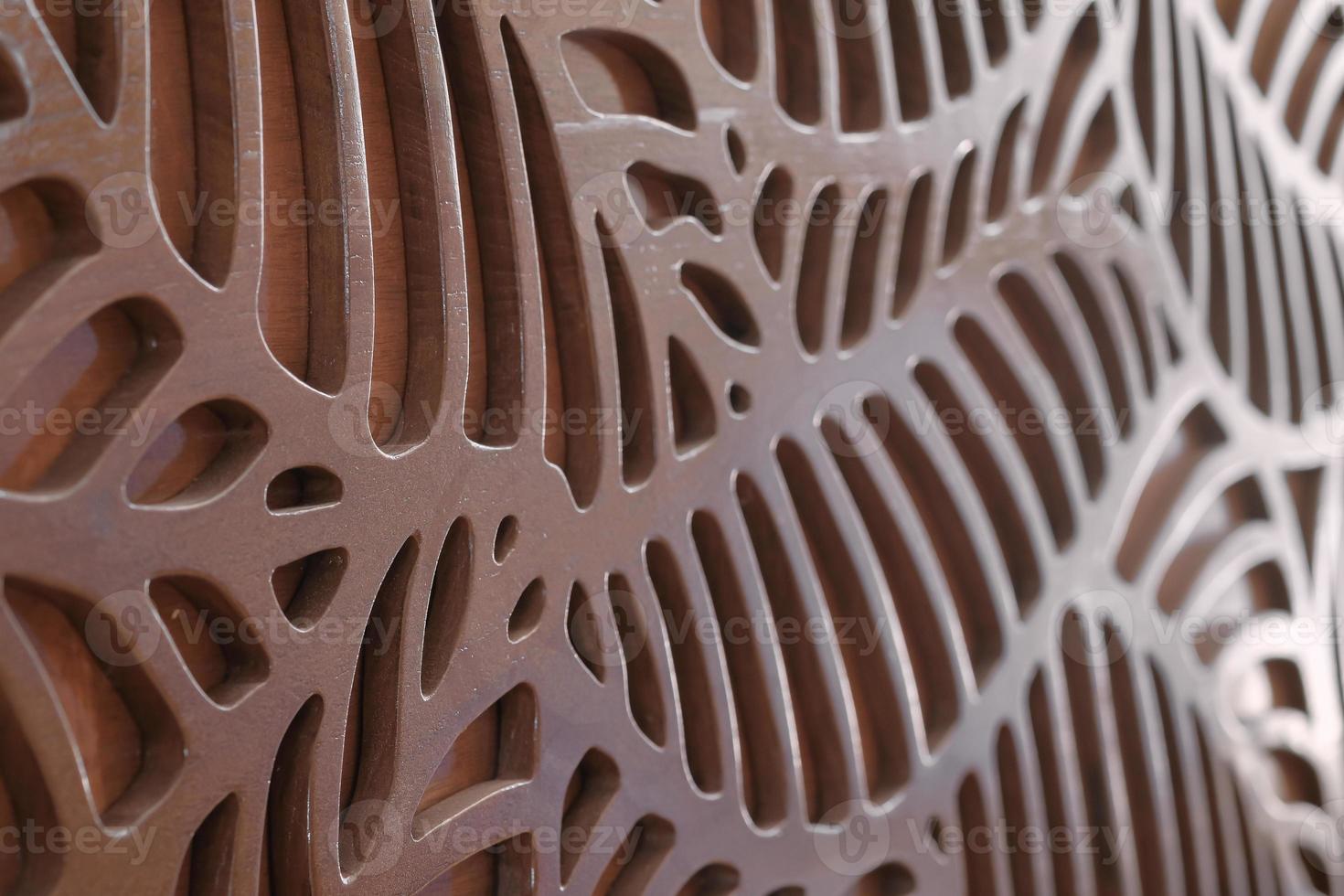 Close up finished teak wooden door engraving grooved texture by CNC laser machine. Selective focus. photo