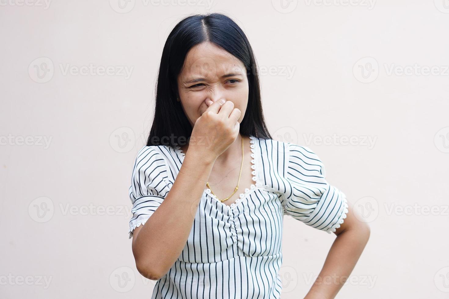 Asian women cover their noses with their hands because they smell bad. photo