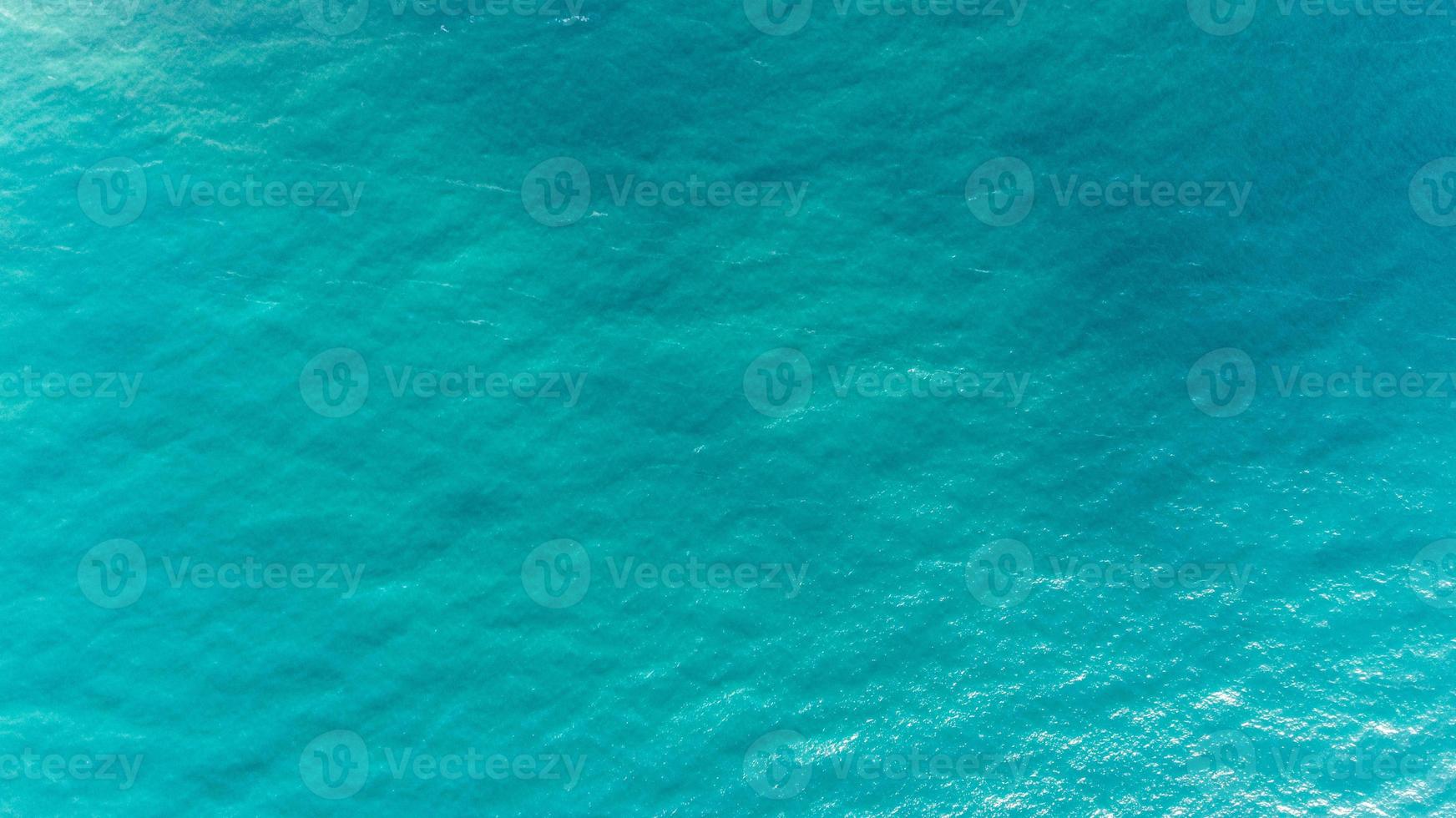 Ocean water texture. Aerial view of sea surface. Top view of transparent turquoise ocean water surface. photo