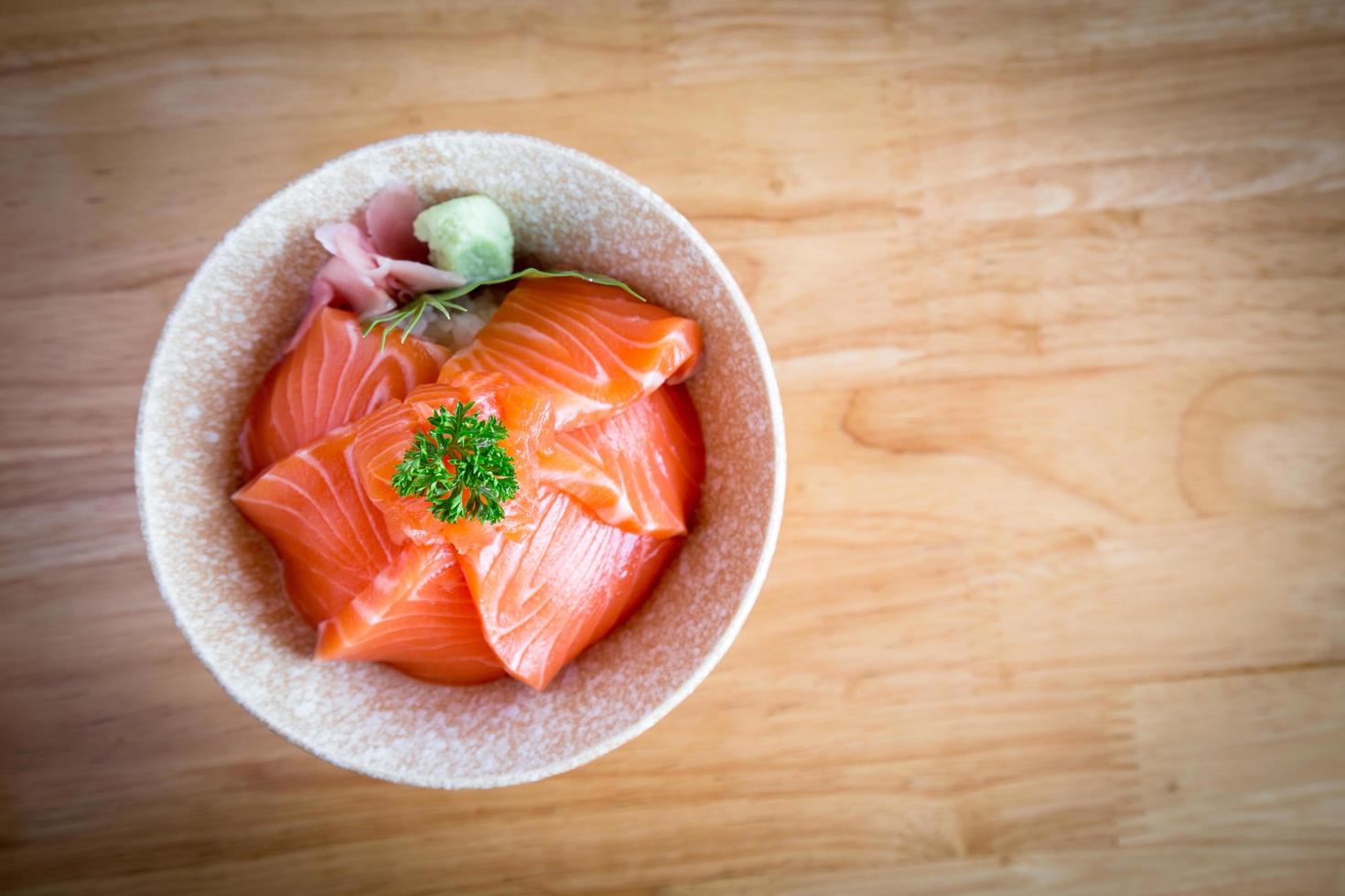 Salmon don Consisting of sliced salmon on top of Japanese rice Served with wasabi. photo