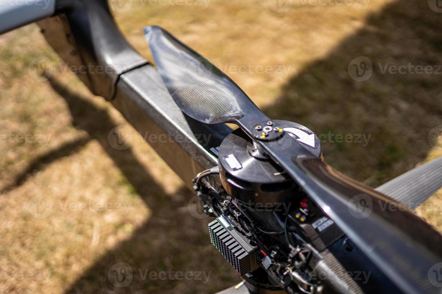 Selective focus on black carbon fiber drone propeller UAV rotor. photo