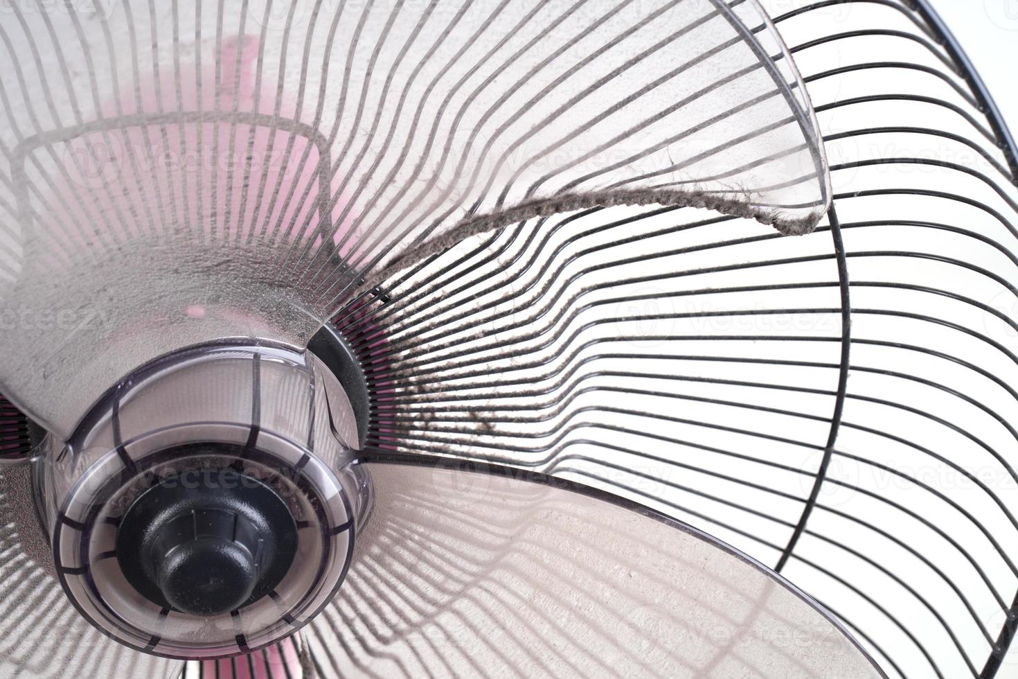 dirty electric fan on white background photo