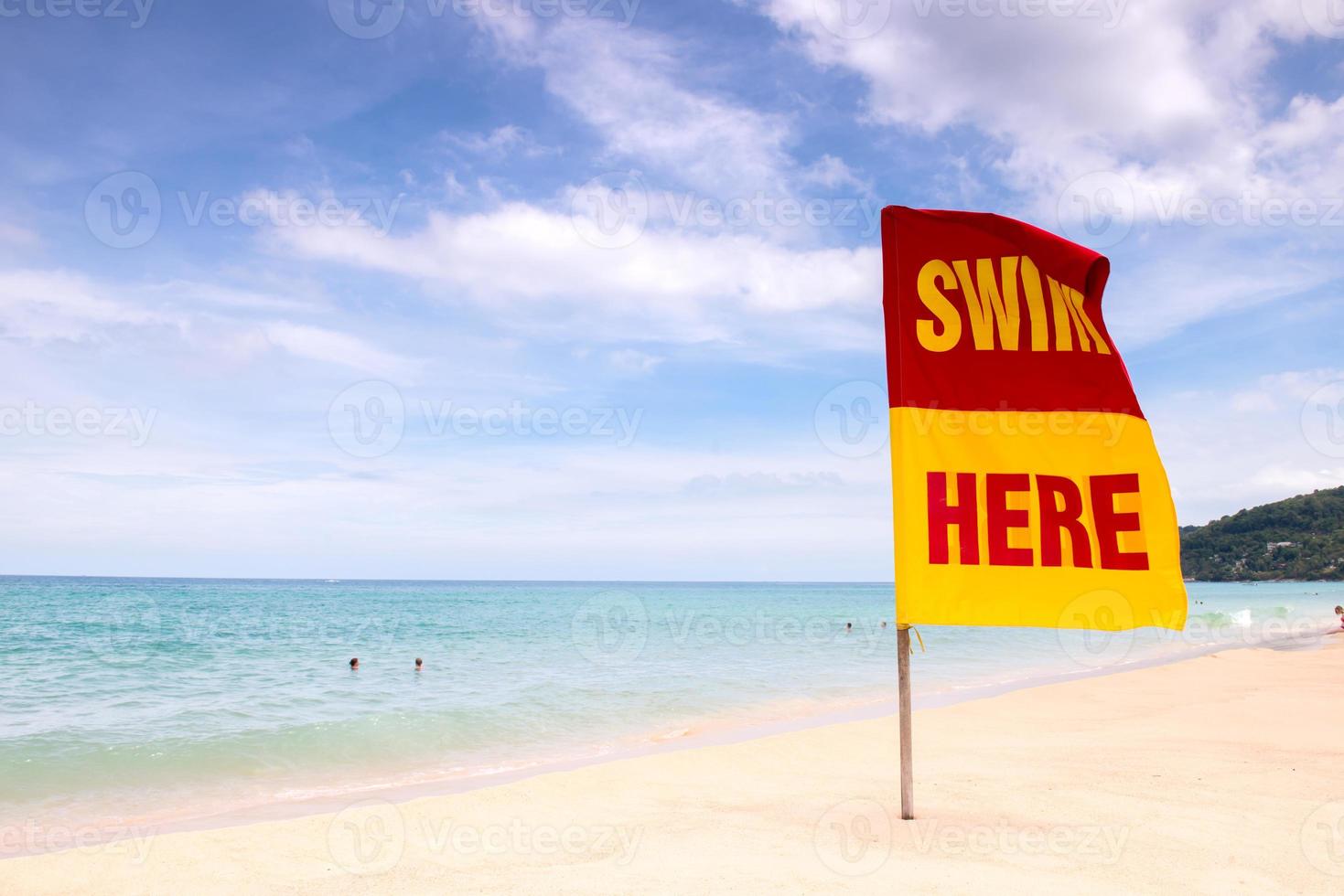 swimming here sign on the beach photo