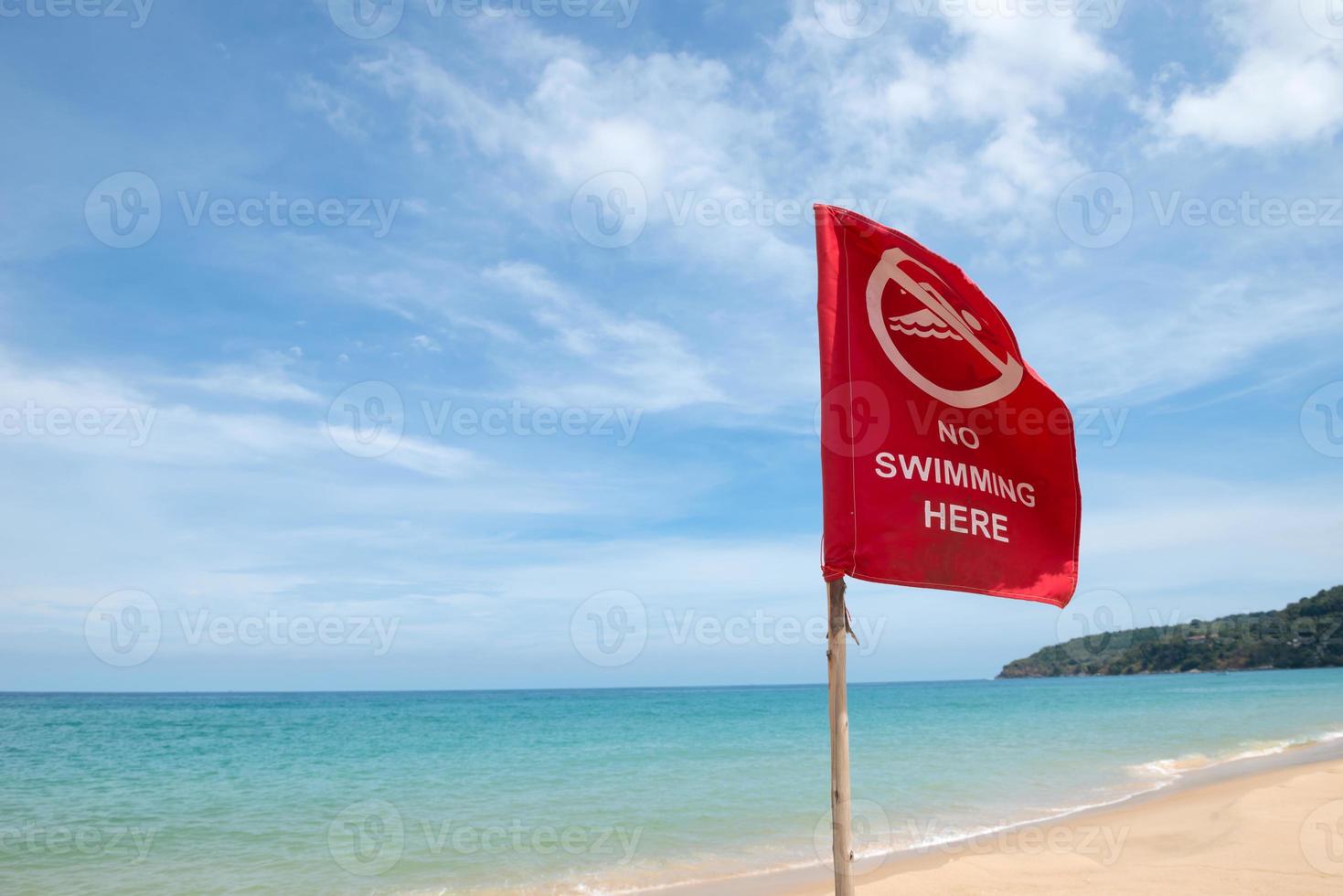 No swimming danger sign at the beach photo