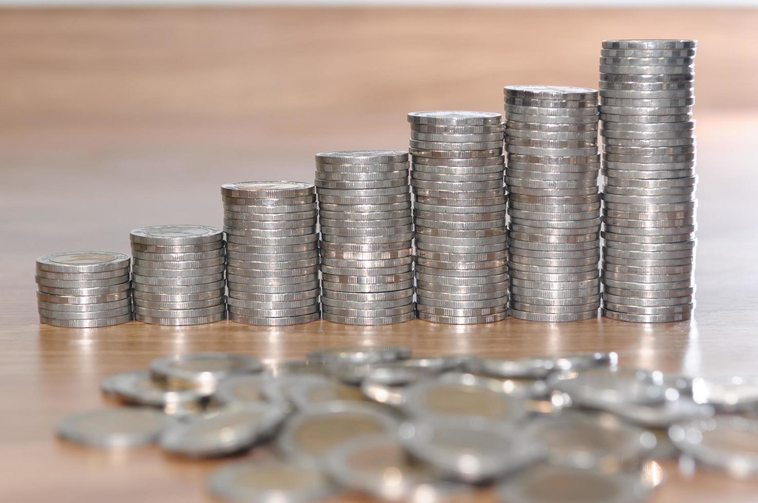 rows of coin stacks on wooden floor. banking concept. metaphor of international financial consulting photo