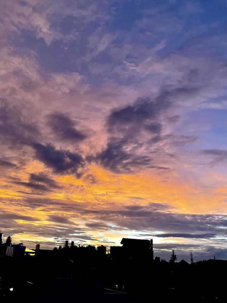 very beautiful twilight sky, a blend of orange and blue colors. beautiful view of the evening sky. clouds, sky and rainbow that adorn the atmosphere in the afternoon. Evening view in Jakarta. blur photo