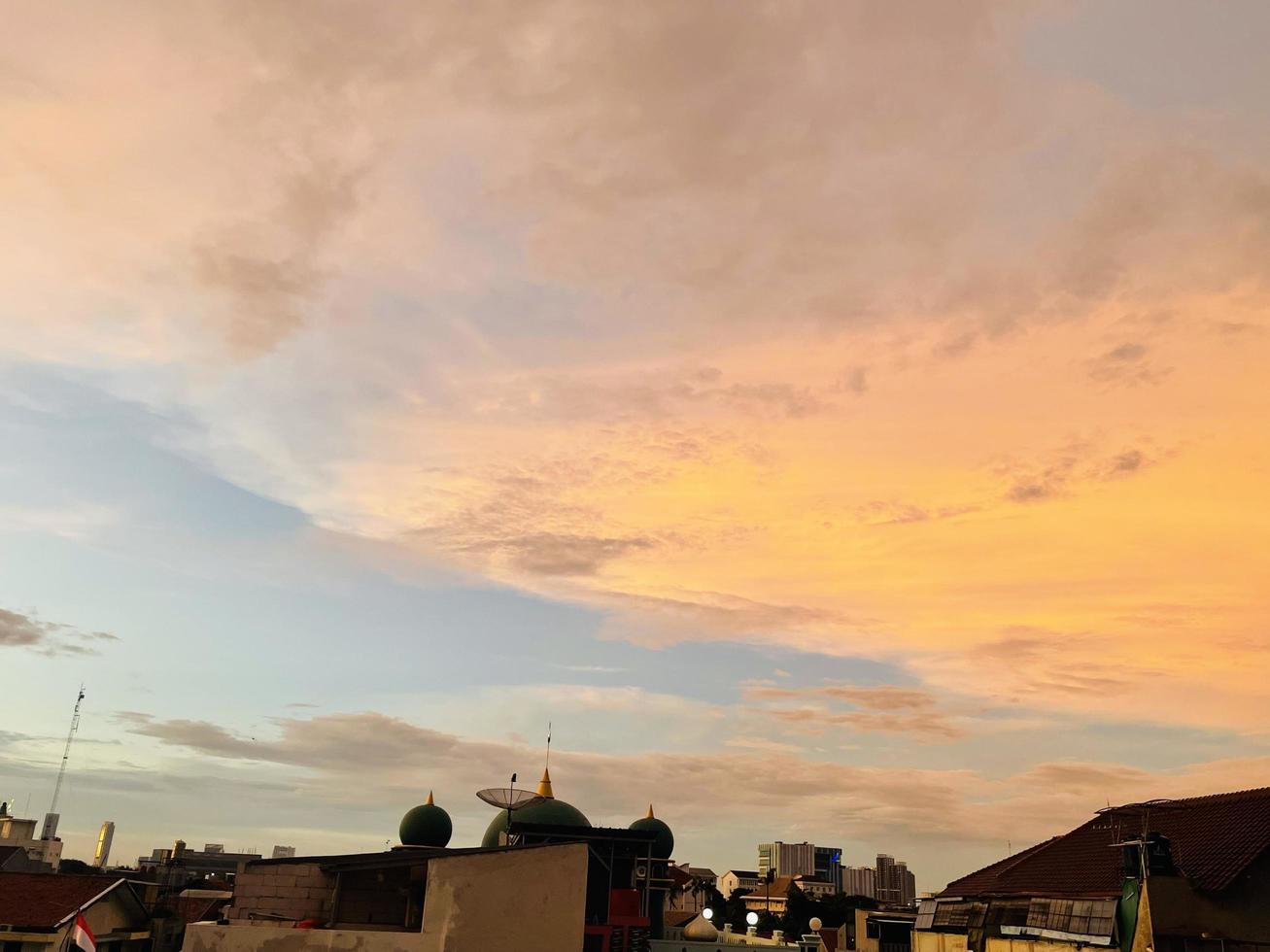 very beautiful twilight sky, a blend of orange and blue colors. beautiful view of the evening sky. clouds, sky and rainbow that adorn the atmosphere in the afternoon. Evening view in Jakarta. blur photo