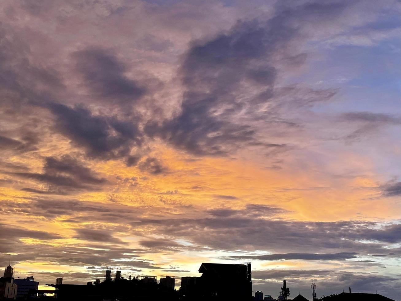 very beautiful twilight sky, a blend of orange and blue colors. beautiful view of the evening sky. clouds, sky and rainbow that adorn the atmosphere in the afternoon. Evening view in Jakarta. blur photo