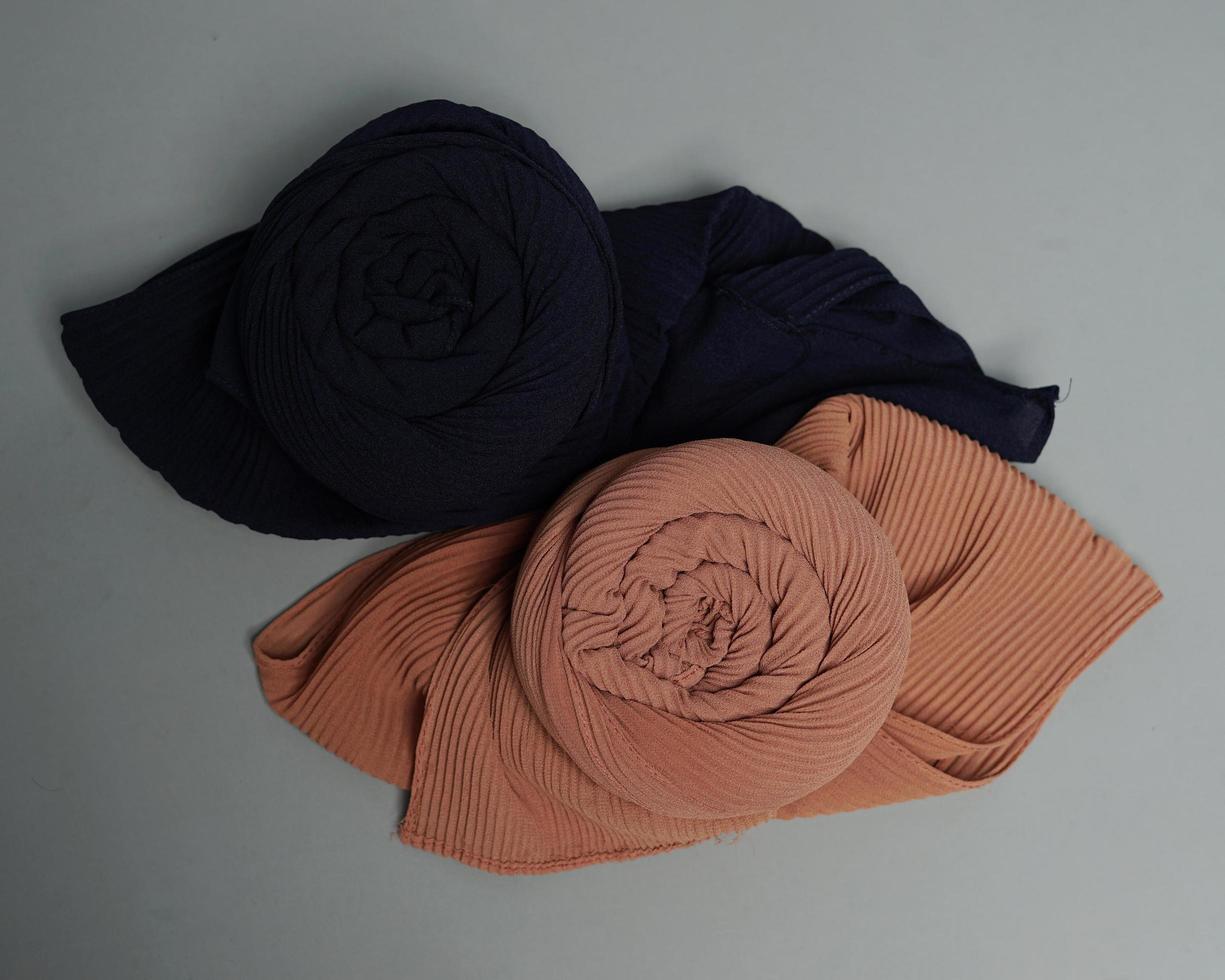 The blend of nude gray fabrics is neatly arranged. Rolled up to resemble flower petals, ready to be used for Muslim women. Fashion needs in the month of Ramadan before Eid. focus blur. Mock up hijab. photo