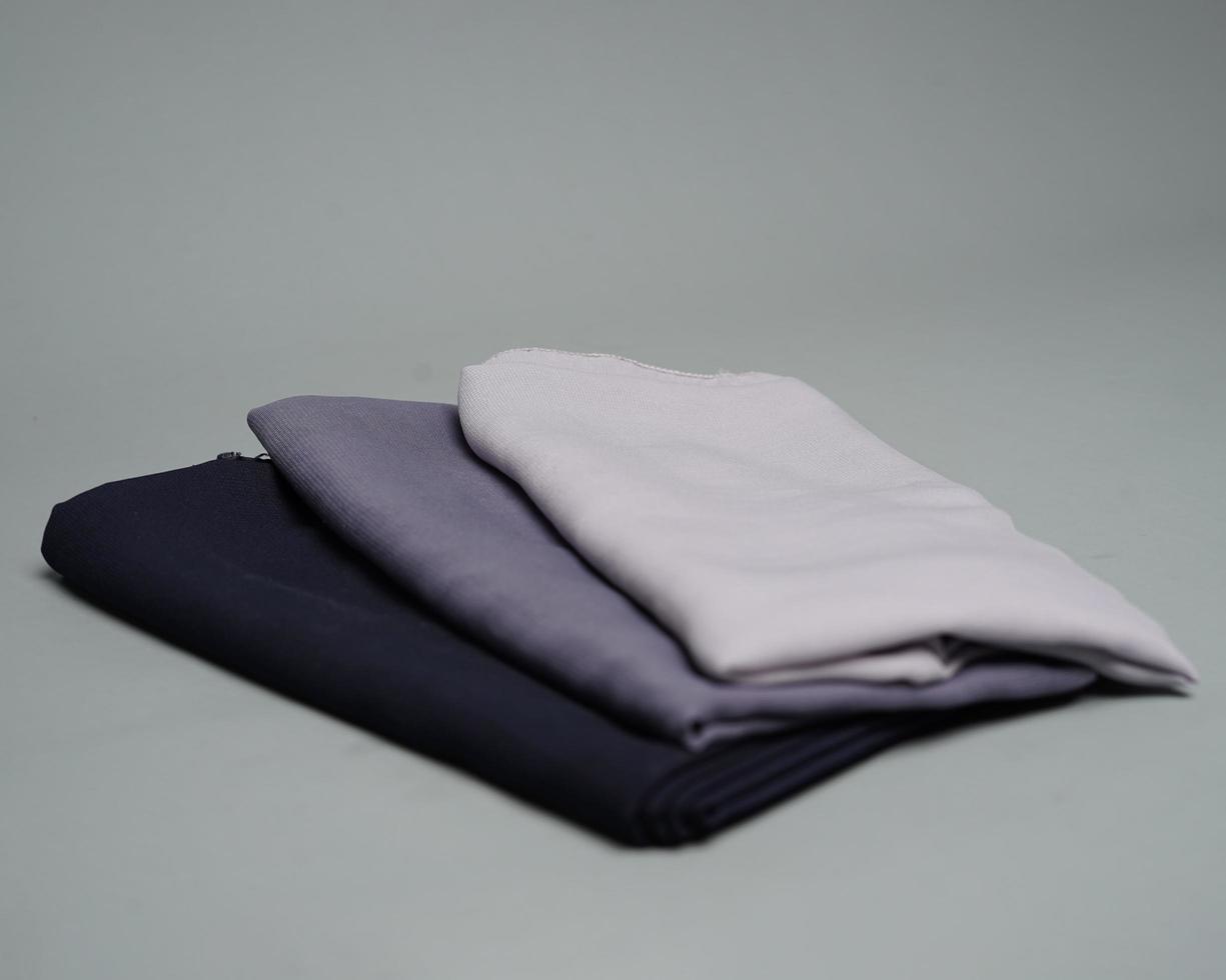 Stacks of nude colored veils neatly arranged on a gray background. Thin fabric blend of gray color that is ready to be used for Muslim women. Can also be used for sales displays. focus blur. hijab. photo