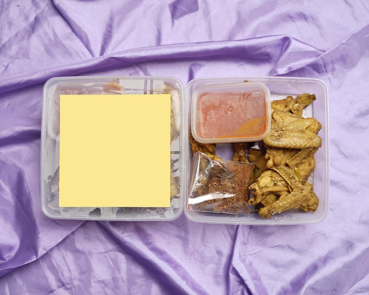 Chicken wrapped with Indonesian spices. Chicken pieces are ready to be fried. Ready-to-eat food in box packaging complete with chili sauce etc. Food packaging mockup box for template. Focus blur. photo