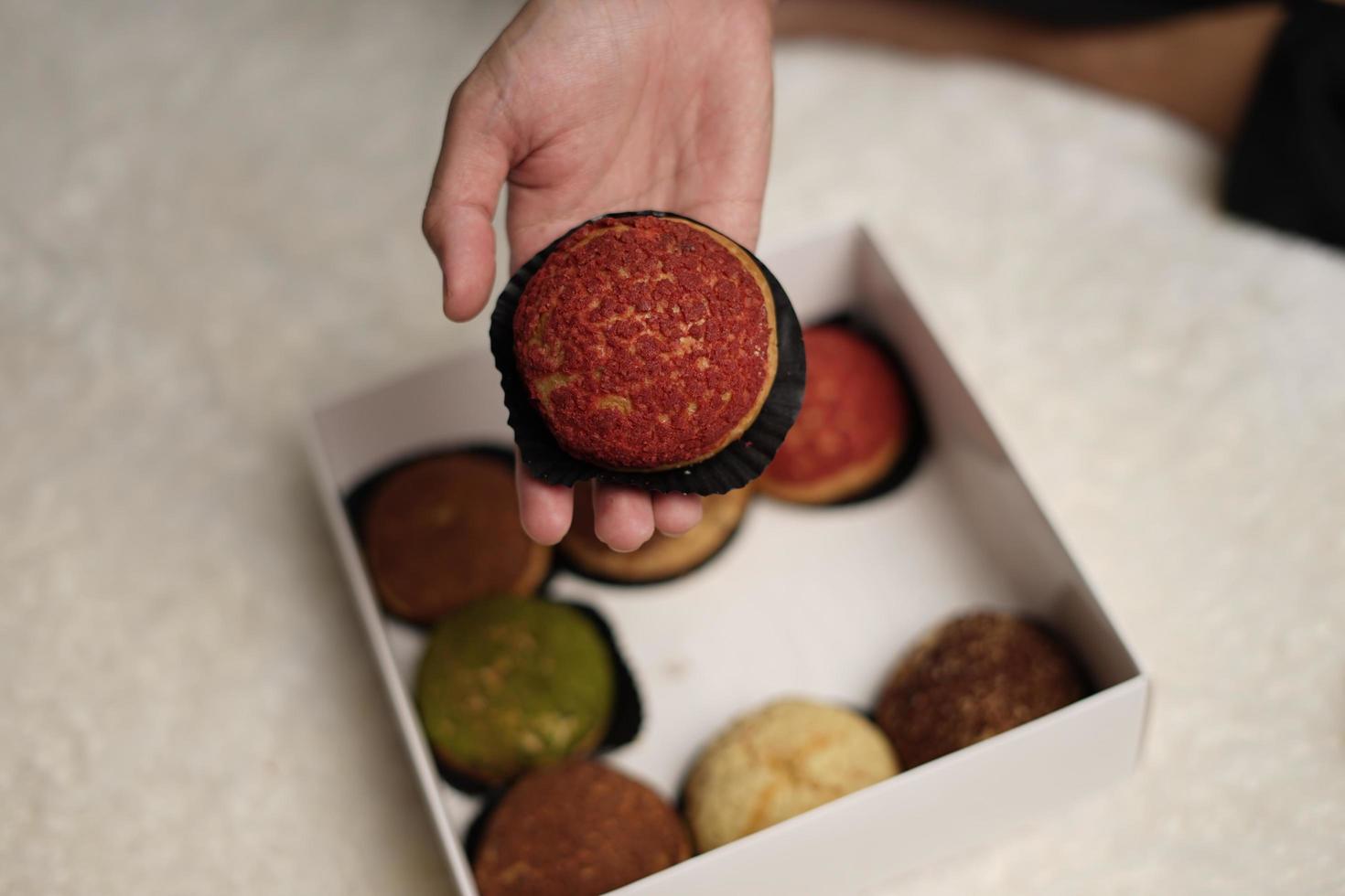 Craquelin choux is a Japanese eclairs with a crispy coating that tastes sweet and creamy. Creampuffs containing various flavors of fla, vanilla, chocolate, matcha. Eid hampers or parcels. focus blur. photo