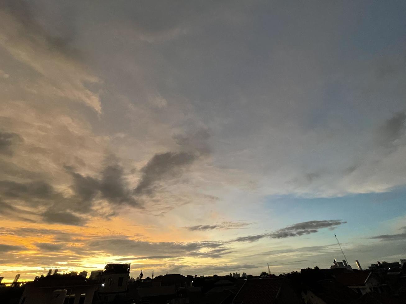 very beautiful twilight sky, a blend of orange and blue colors. beautiful view of the evening sky. clouds, sky and rainbow that adorn the atmosphere in the afternoon. Evening view in Jakarta. blur photo