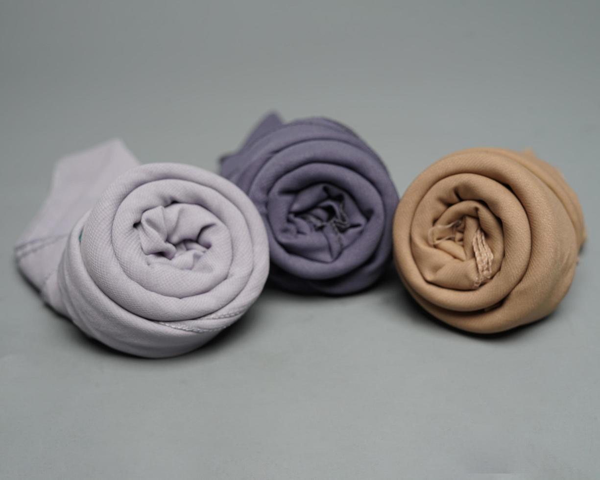 The blend of nude gray fabrics is neatly arranged. Rolled up to resemble flower petals, ready to be used for Muslim women. Fashion needs in the month of Ramadan before Eid. focus blur. Mock up hijab. photo