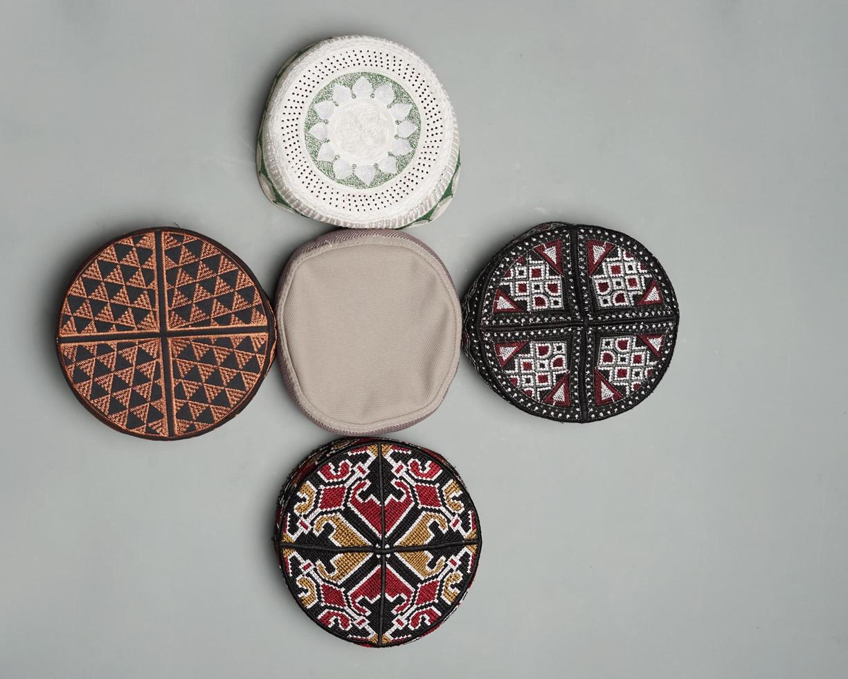 Collection of kopiah hat or peci with a variety of color and shape motifs. Peci that is usually used for Muslim men while praying to the mosque. Islamic cap isolated on white background. Ied mubarok. photo