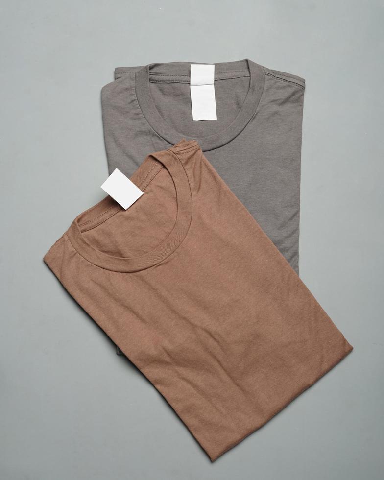 Stacks of plain cotton t-shirts neatly arranged. Plain colorful t-shirts, ready to be made into design mockups. T-shirts are clean without any branding. Men's blank T-shirt template. focus blur. eid photo