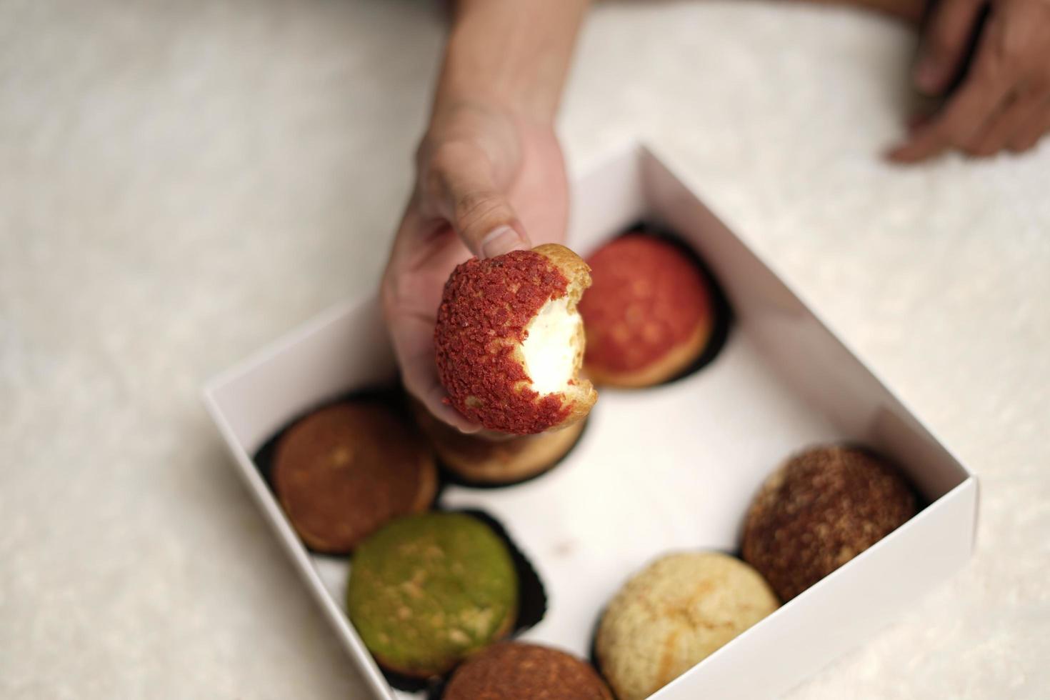 Craquelin choux is a Japanese eclairs with a crispy coating that tastes sweet and creamy. Creampuffs containing various flavors of fla, vanilla, chocolate, matcha. Eid hampers or parcels. focus blur. photo