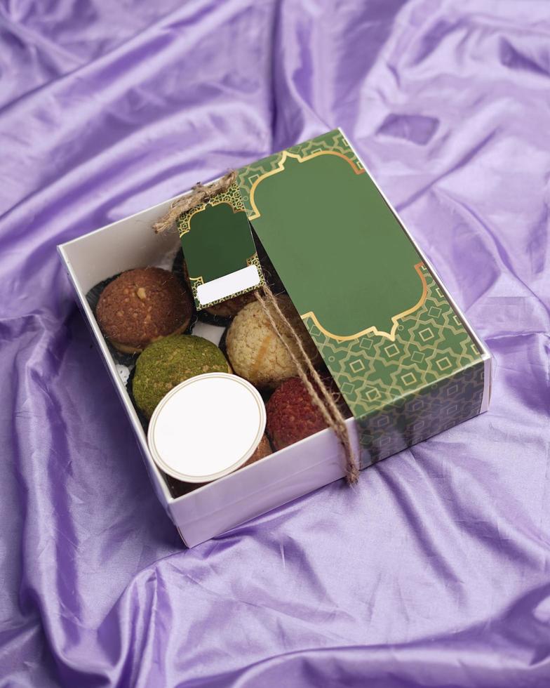 Eid hampers or parcels. Cake box containing creampuff or craquelin in various flavors and colors. Cake Box decorated with space for the customer's brand name. Cake Mockup template design. focus blur. photo