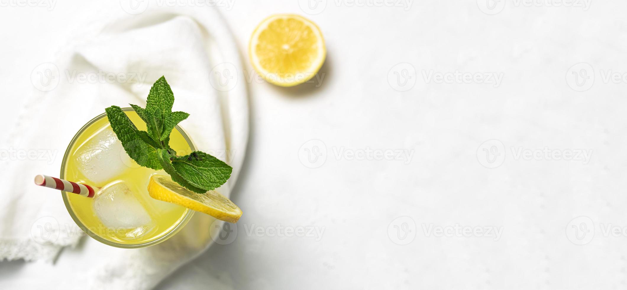 Fresh Lemonade or mojito cocktail with lemon, mint and ice photo