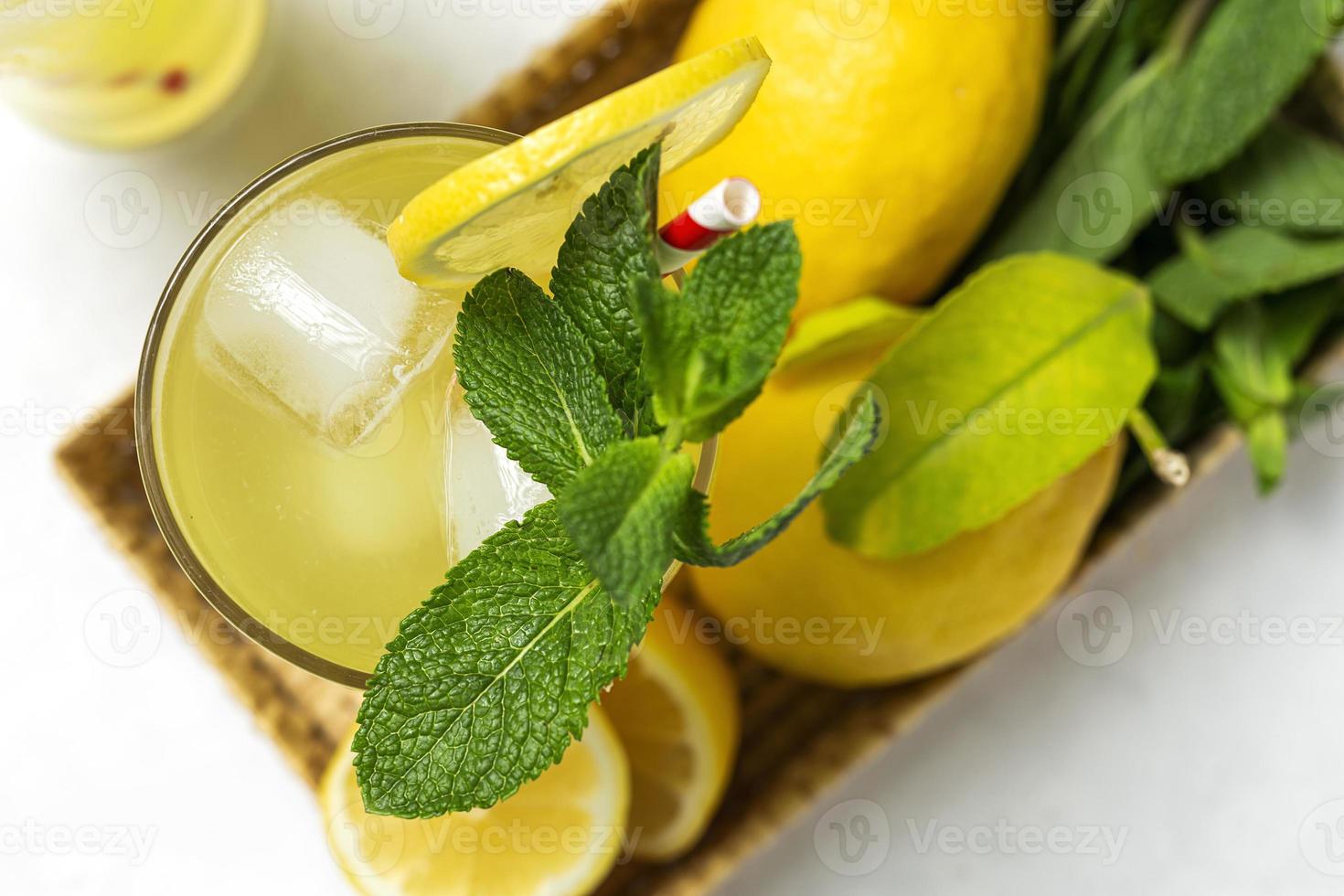 Fresh Lemonade or mojito cocktail with lemon, mint and ice photo