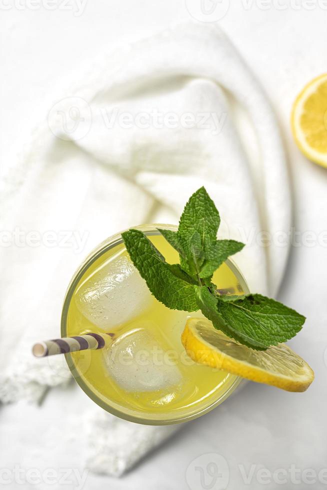 Fresh Lemonade or mojito cocktail with lemon, mint and ice photo