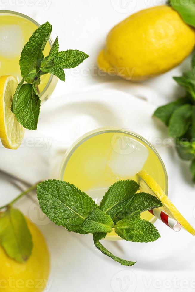 Fresh Lemonade or mojito cocktail with lemon, mint and ice photo