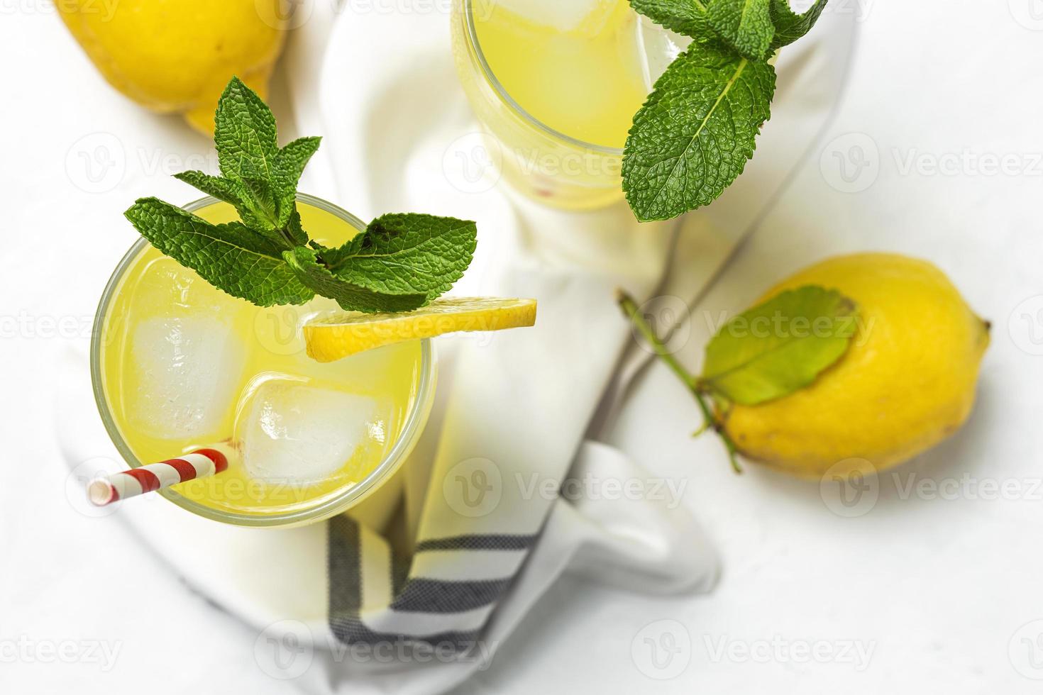 Fresh Lemonade or mojito cocktail with lemon, mint and ice photo