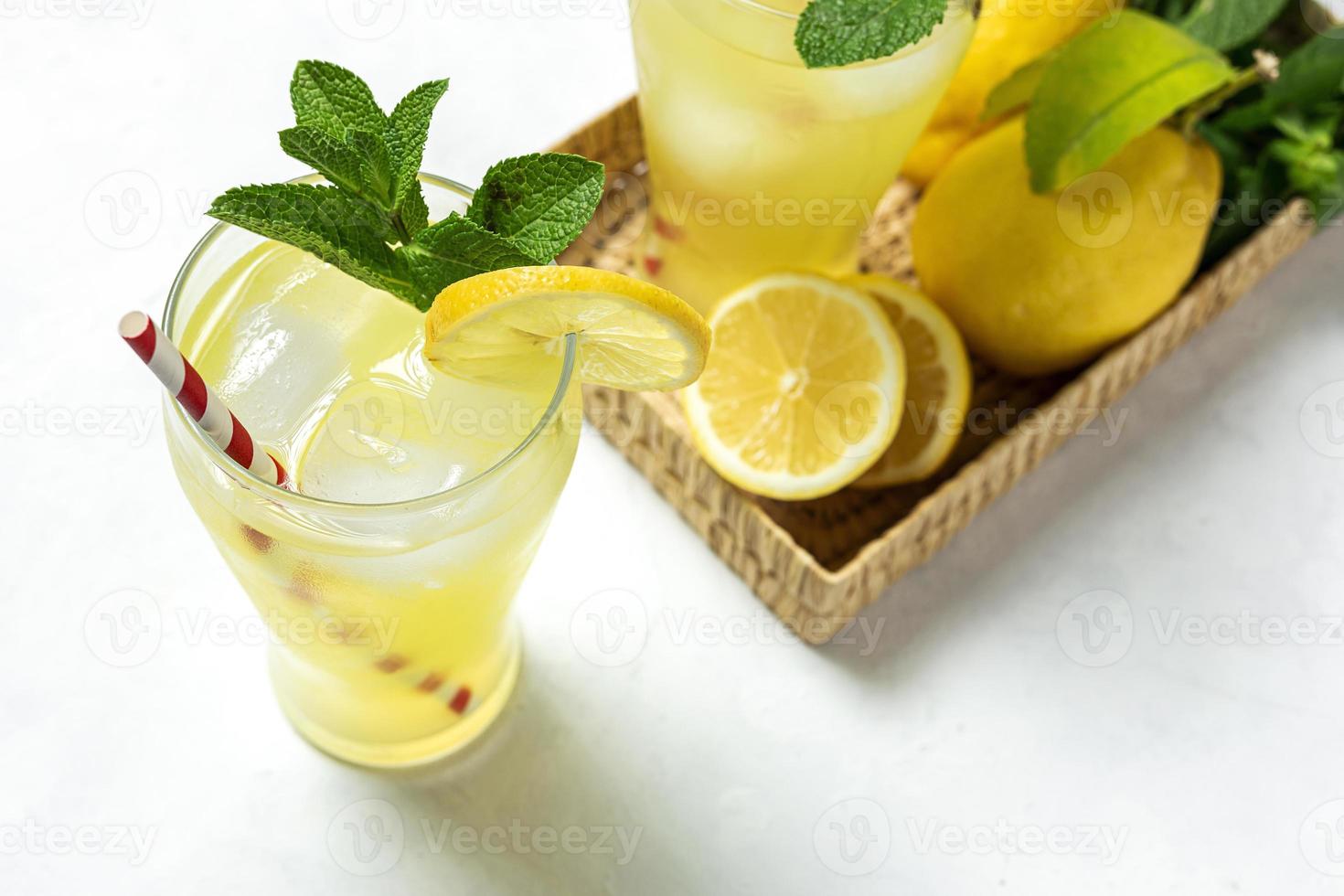 Fresh Lemonade or mojito cocktail with lemon, mint and ice photo