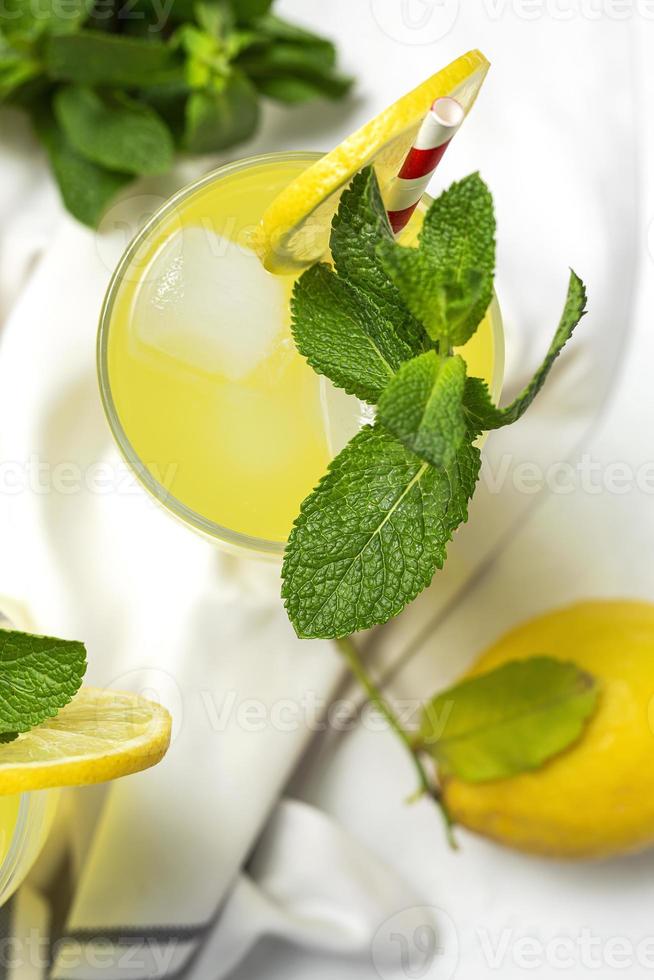 Fresh Lemonade or mojito cocktail with lemon, mint and ice photo