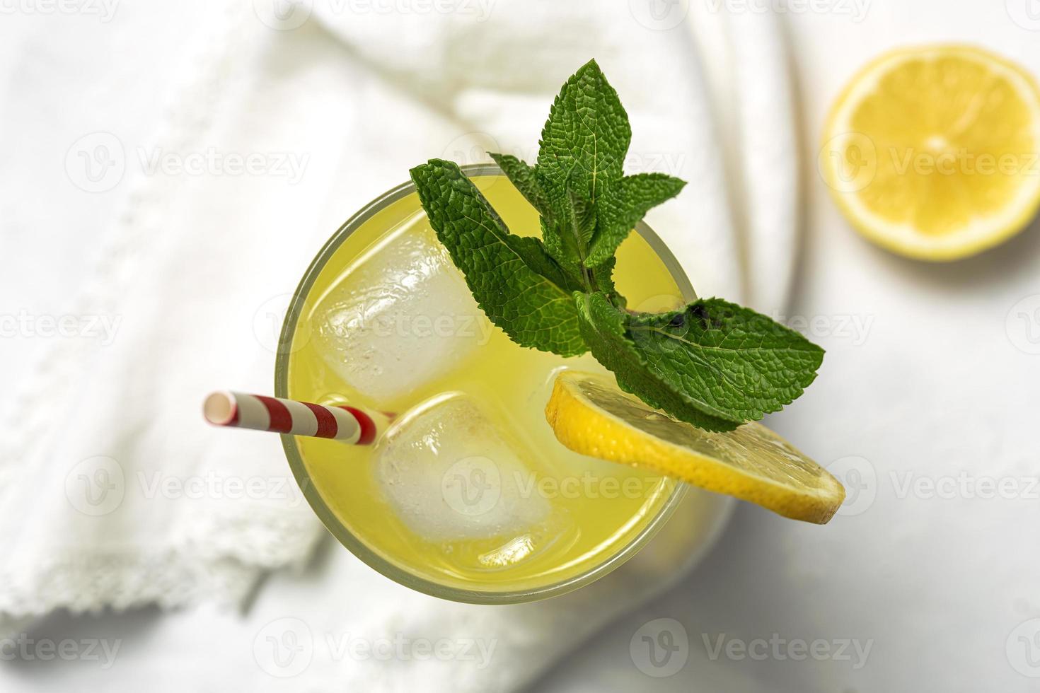 Fresh Lemonade or mojito cocktail with lemon, mint and ice photo