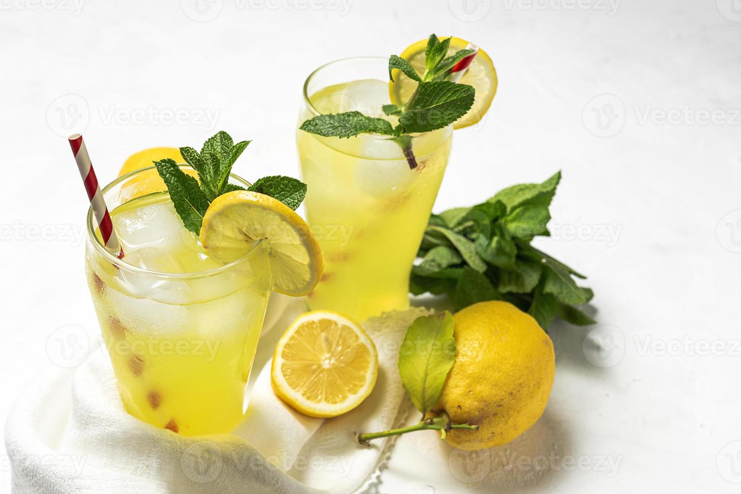 Fresh Lemonade or mojito cocktail with lemon, mint and ice photo