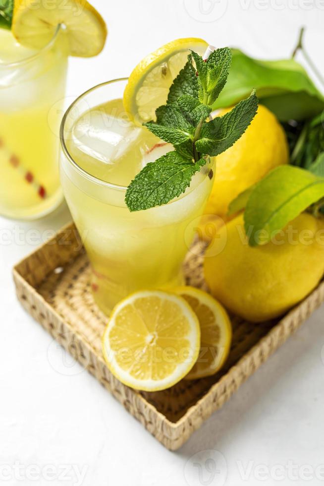 Fresh Lemonade or mojito cocktail with lemon, mint and ice photo