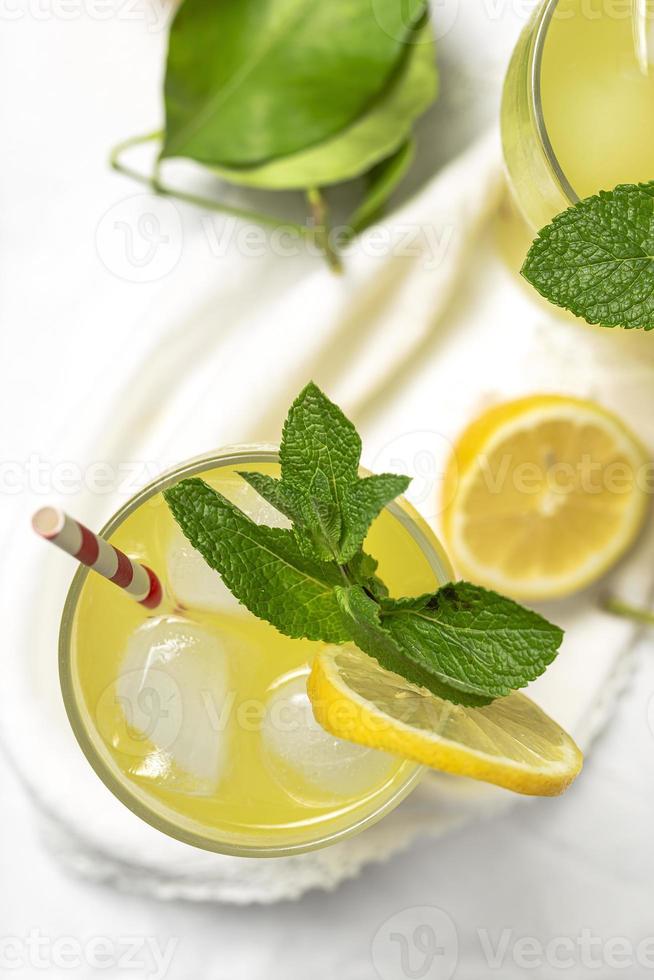 Fresh Lemonade or mojito cocktail with lemon, mint and ice photo