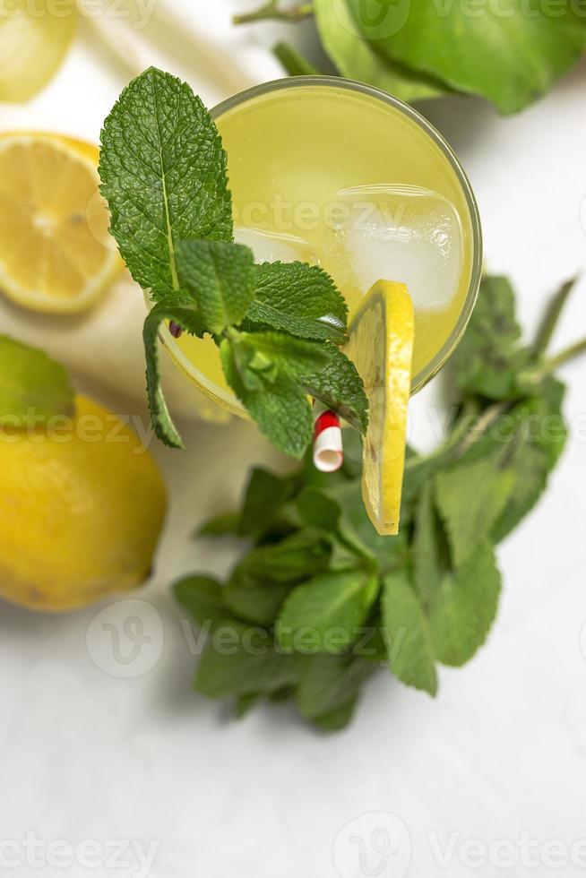 Fresh Lemonade or mojito cocktail with lemon, mint and ice photo