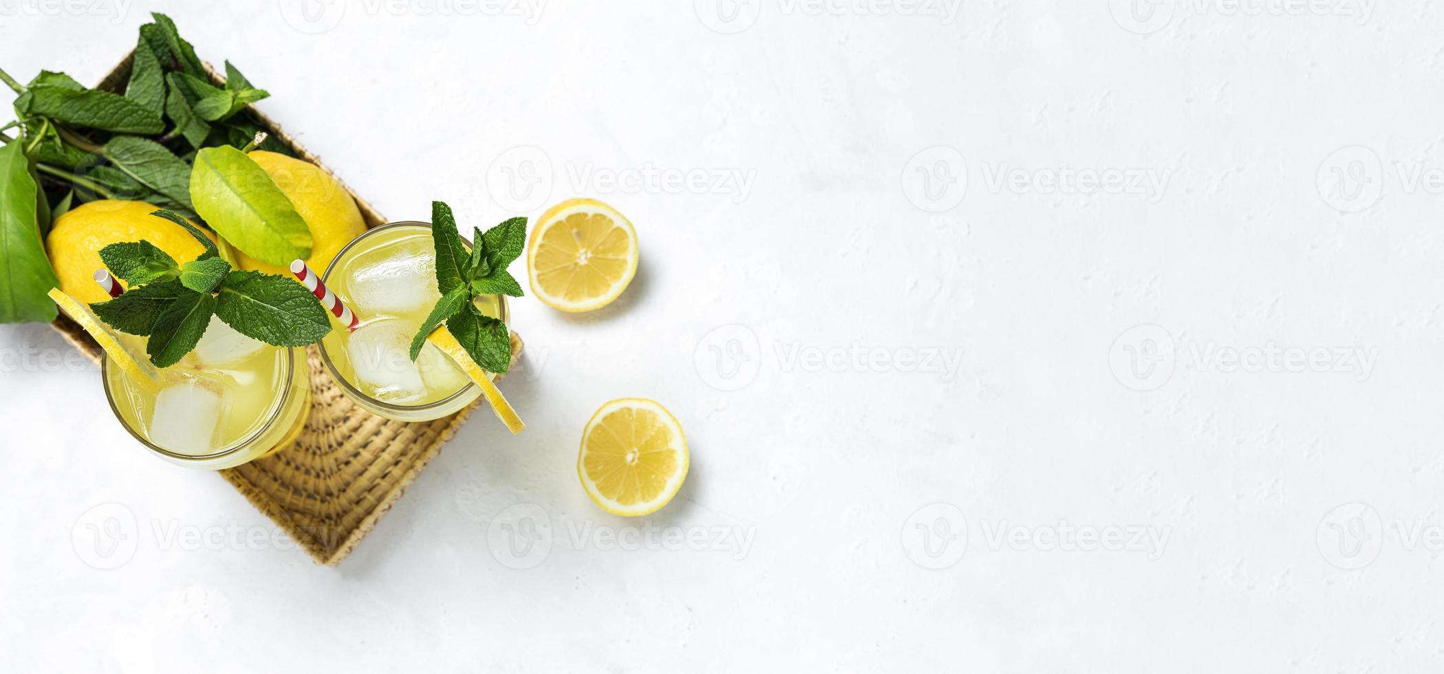Fresh Lemonade or mojito cocktail with lemon, mint and ice photo