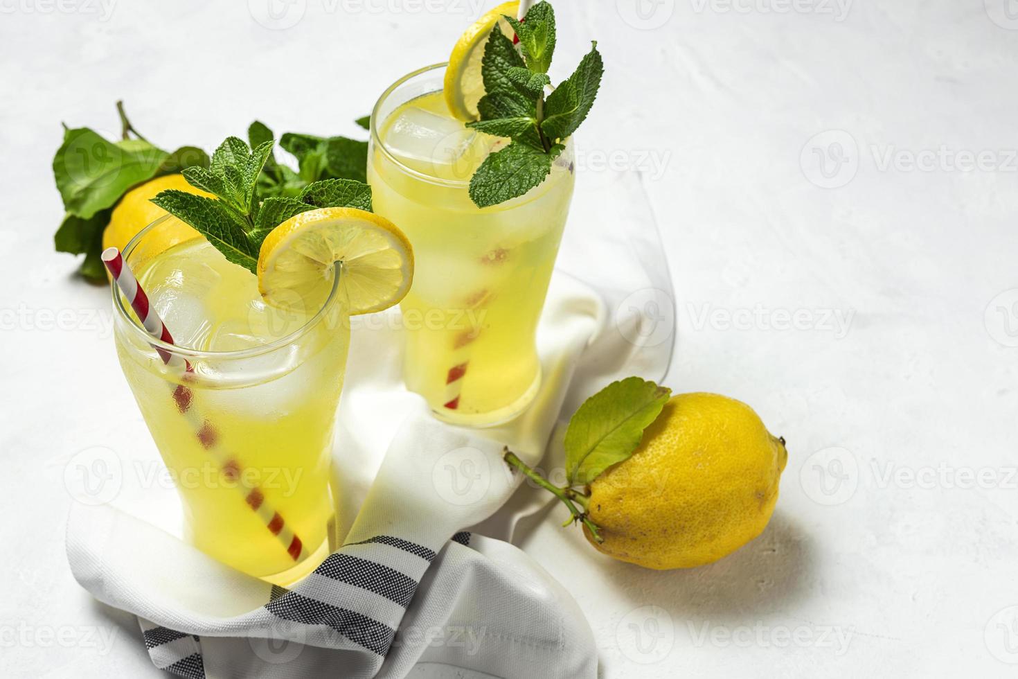 Fresh Lemonade or mojito cocktail with lemon, mint and ice photo