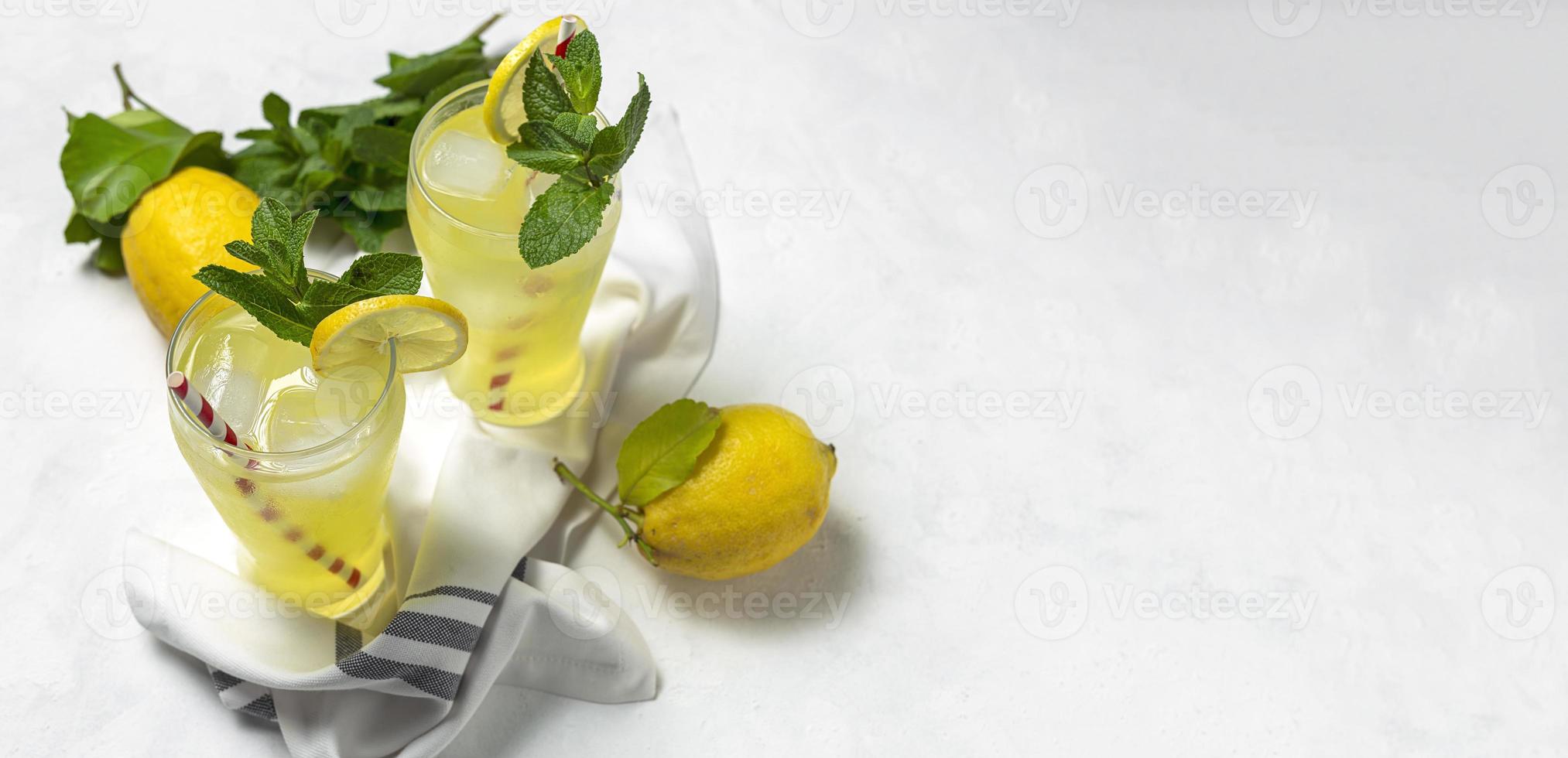 Fresh Lemonade or mojito cocktail with lemon, mint and ice photo