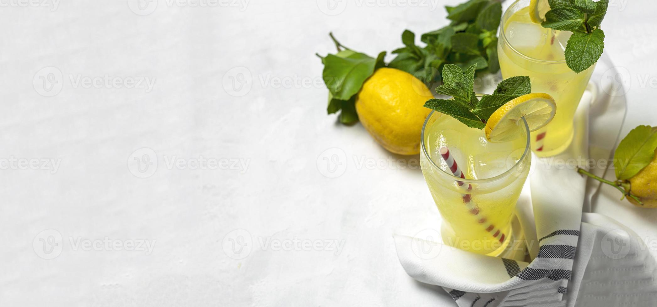 Fresh Lemonade or mojito cocktail with lemon, mint and ice photo
