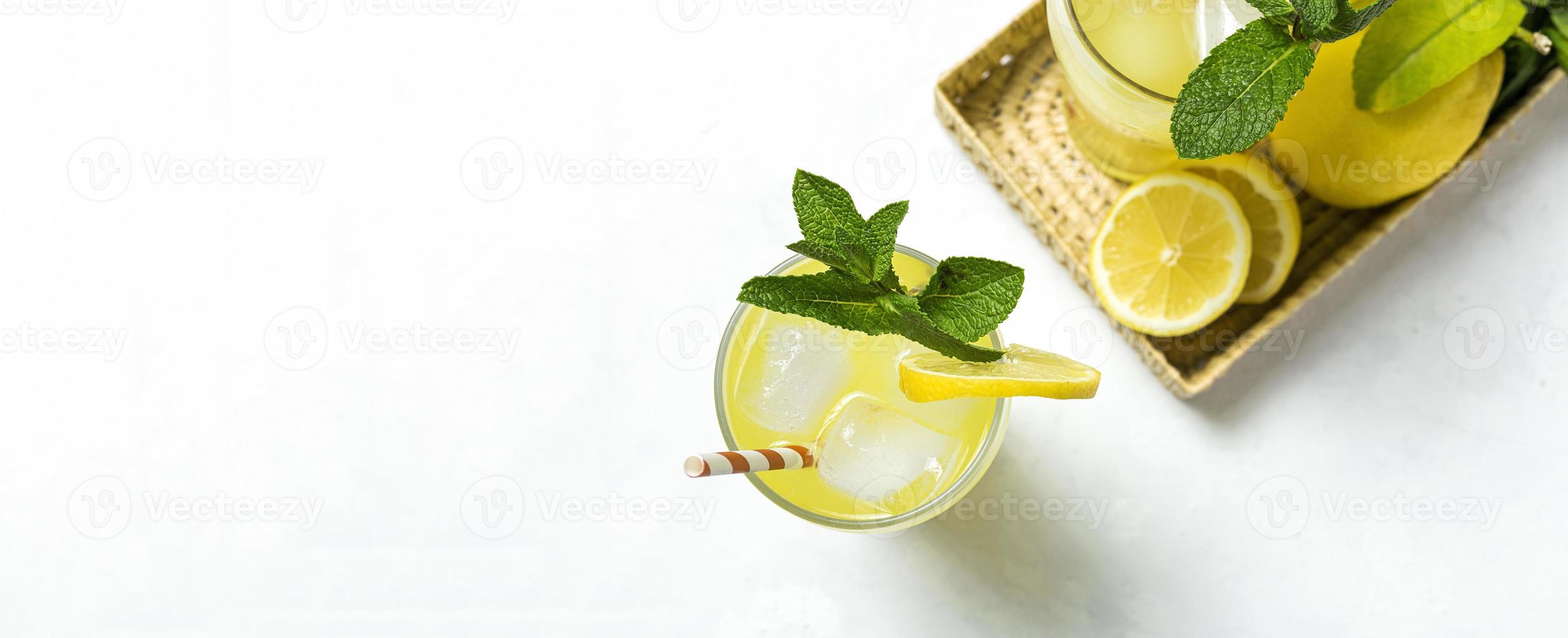 Fresh Lemonade or mojito cocktail with lemon, mint and ice photo